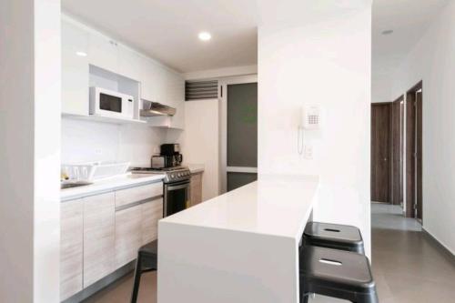 a kitchen with white cabinets and a white counter top at San Ángel UNAM 3 recámaras/2parking in Mexico City