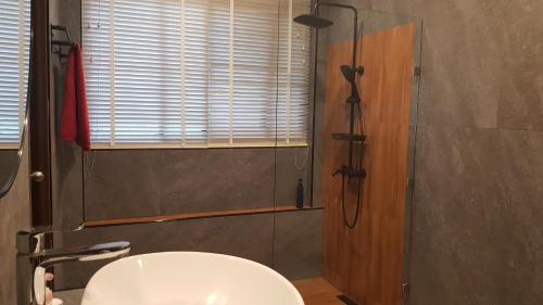 a bathroom with a shower and a white sink at Genesis villa- front beach peaceful villa big infinity swimming pool in Amphoe Koh Samui