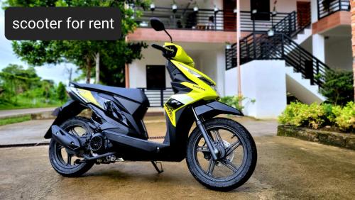 a yellow and black motorcycle parked in front of a house at Matilde B&B - La Paz, Carmen in Carmen
