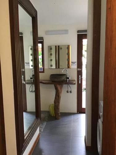 a bathroom with a sink and a mirror at Forest views in Diwan