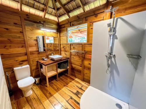 ein Bad mit einem WC und einem Waschbecken in der Unterkunft RAIATEA - Bungalow Nautilus Pool in Uturoa