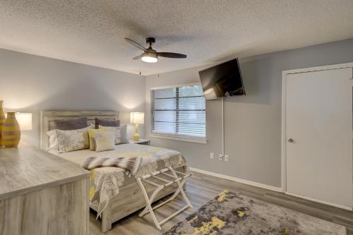 a bedroom with a bed with a ceiling fan and a window at #111 Elaborate Condo Ideal Location 2BRM/2 Parking in Hilton Head Island