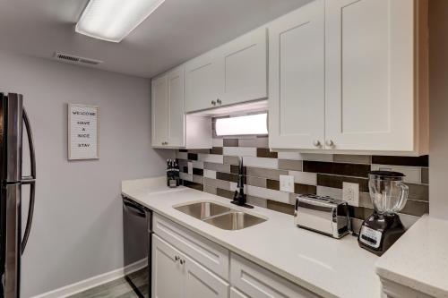a kitchen with white cabinets and a counter top at #111 Elaborate Condo Ideal Location 2BRM/2 Parking in Hilton Head Island