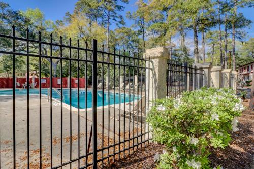 an iron fence with a swimming pool behind it at #114 Colorful Charming Condo 2BDR/2 Parking in Hilton Head Island