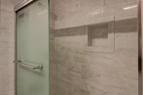 a shower with a glass door in a bathroom at #114 Colorful Charming Condo 2BDR/2 Parking in Hilton Head Island