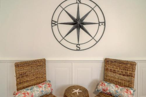 two chairs in a room with a large clock on the wall at #114 Colorful Charming Condo 2BDR/2 Parking in Hilton Head Island