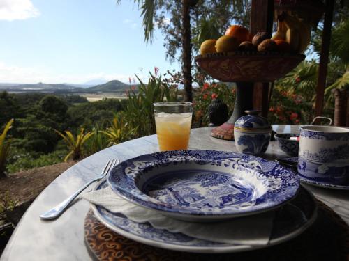 a table with a bowl of fruit and a glass of orange juice at Mai Tai Resort in Cassowary