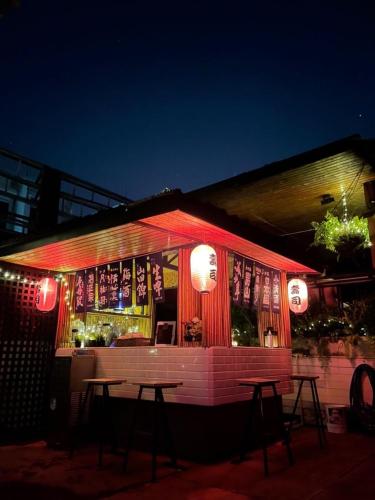 a restaurant with a table in front of it at night at Blu Cabin Ari Stylish Gay Poshtel in Bangkok