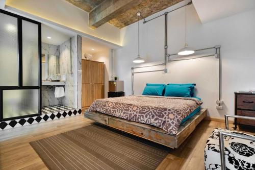 a bedroom with a bed with blue pillows at Blu Cabin Ari Stylish Gay Poshtel in Bangkok