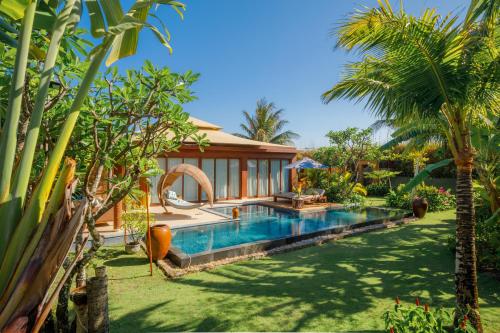an image of a villa with a swimming pool at Fusion Resort Cam Ranh - All Spa Inclusive in Cam Ranh