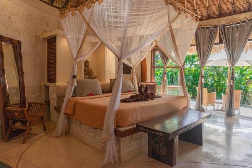 A bed or beds in a room at La Joya Balangan Resort