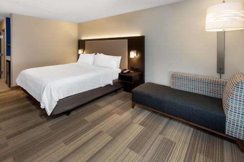 a hotel room with a bed and a couch at Holiday Inn Express Minden by IHG in Minden