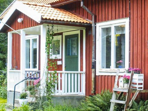 a red house with a white door and windows at 3 person holiday home in Tystberga in Tystberga