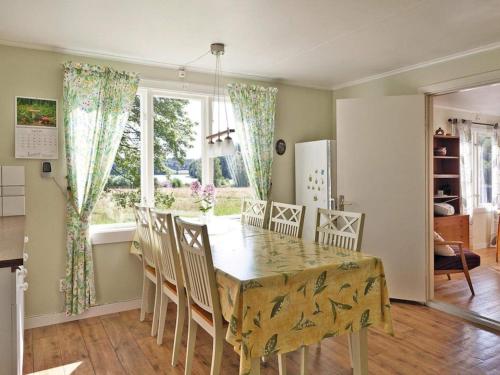 a dining room with a table and chairs and a window at 6 person holiday home in Br landa in Brålanda
