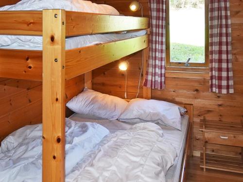 a bedroom with two bunk beds in a cabin at 6 person holiday home in Bud-By Traum in Bud