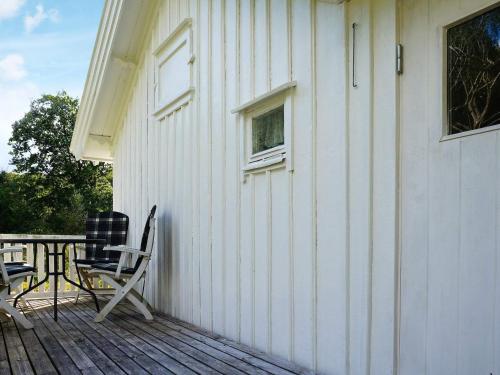 a patio with two chairs and a table on a house at 5 person holiday home in FISKEB CKSKIL in Fiskebäckskil