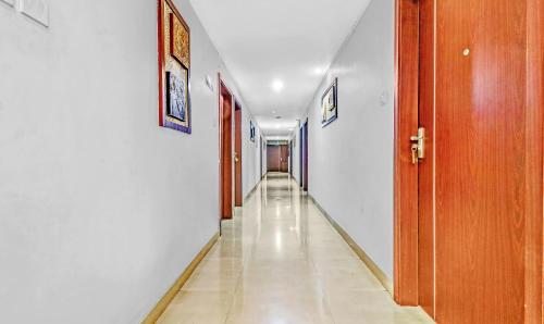 a hallway with white walls and a long hall at Treebo Symphony Hotels And Resorts Angamally in Kizhake Chālakudi