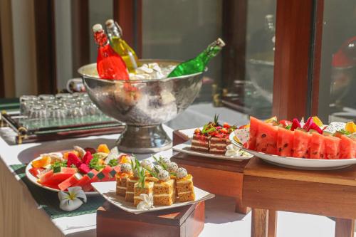 a buffet with waffles and fruit on a table at Fusion Resort Cam Ranh - All Spa Inclusive in Cam Ranh
