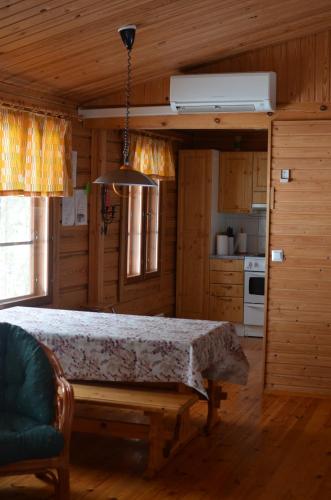 a kitchen with a bed in a wooden room at Turjanlinna in Rantasalmi