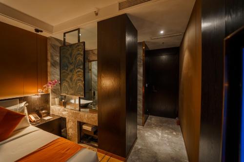 a hotel room with a bed and a bathroom at OCEAN HOTEL in Phnom Penh