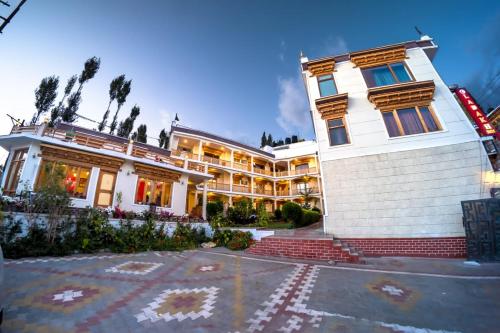 a large white building with a lot of windows at Hotel Ladakh Inn in Leh