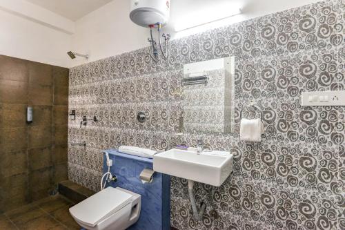 a bathroom with a sink and a toilet at Mount Amara Hotel & Spa, Siliguri in Siliguri