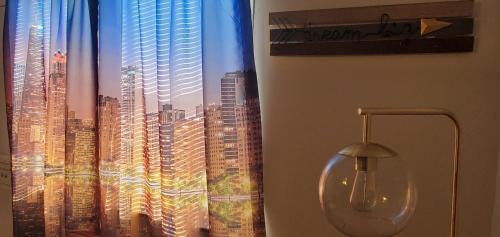 a window with a view of a city at Cozy 1 bedroom, 1 min from Irving Park Blue line, free parking in Chicago