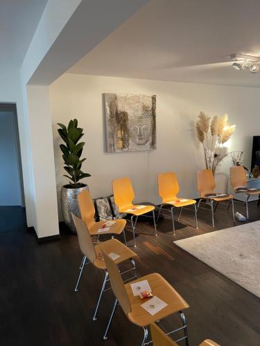 a group of chairs and tables in a room at Gemütliche Villa am Waldrand in Taunusstein in Taunusstein