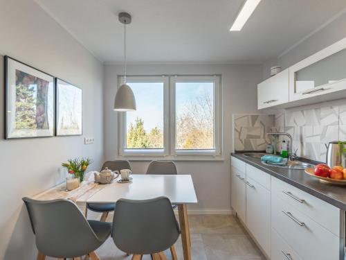 a kitchen with a table and chairs in a kitchen at Holiday home on the mountain with views in Ballenstedt