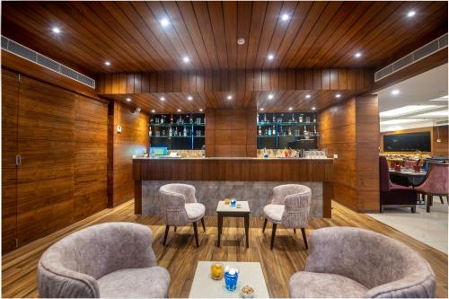 a bar with chairs and a table in a room at Lords Inn Chandigarh Zirakpur in Zirakpur