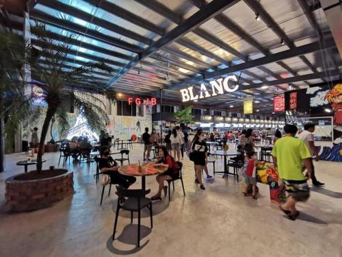 a group of people walking around a shopping mall at Seaview condo near RF Mall, Food Court & Free Netflix in Johor Bahru