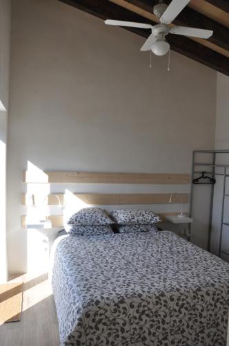a bedroom with a bed with a ceiling fan at Ca'n Guiri, Eco Finca in Mallorca in Campanet