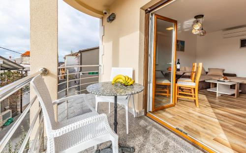 a balcony with a table with bananas on it at Medulinka apartments in Medulin
