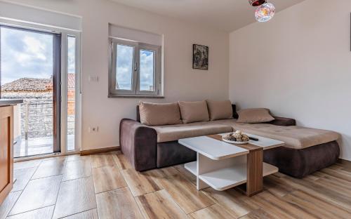 a living room with a couch and a table at Medulinka apartments in Medulin