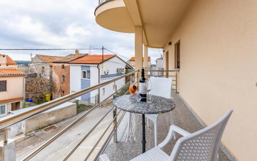 a balcony with a table and chairs and a view at Medulinka apartments in Medulin