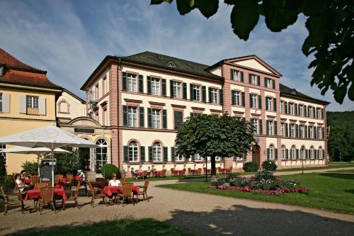 a large building with tables and chairs in front of it at Badhotel Bad Brückenau in Staatsbad Brückenau