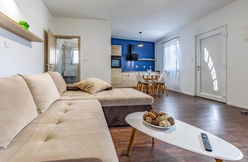 a living room with a couch and a table at Medulinka apartments in Medulin