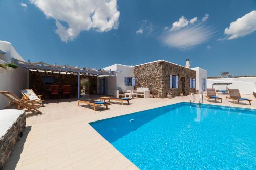 a villa with a swimming pool and a house at Crystal Villa II in Chrissi Akti