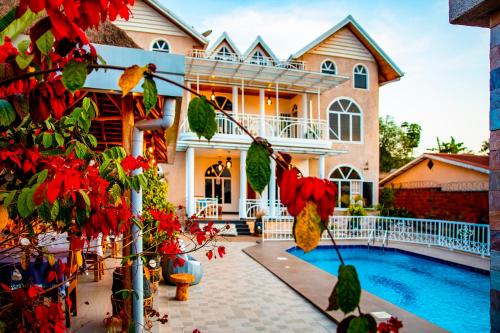 a house with a swimming pool in front of it at Villa Asimba in Kigali