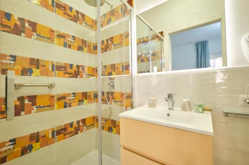 a bathroom with a shower and a sink and a mirror at Piovella in Cagliari