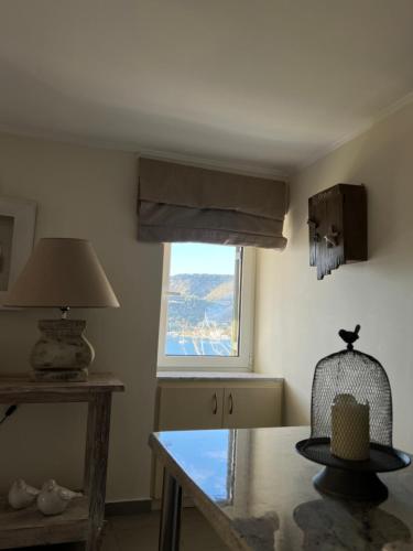 a dining room with a table and a window at Kasteli Suite in Poros