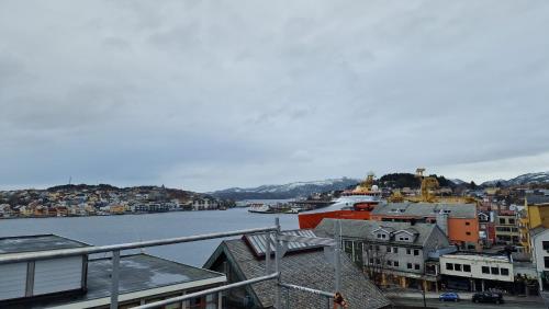 a view of a city with a river and buildings at Lovely 2-bedroom loft with panoramic view. in Kristiansund