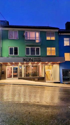 a building with a neon sign on the side of it at Lovely 2-bedroom loft with panoramic view in Kristiansund