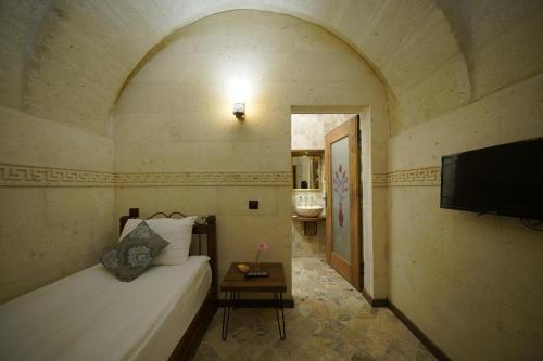 Ένα ή περισσότερα κρεβάτια σε δωμάτιο στο Arte Cave Hotel