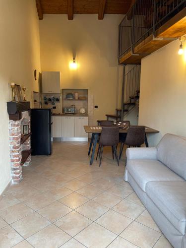 a living room with a couch and a table at Langhetruffle apartment in La Morra