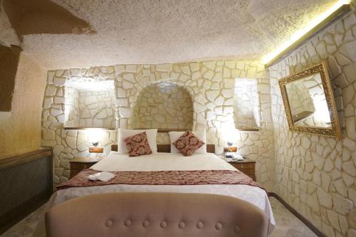 Ένα ή περισσότερα κρεβάτια σε δωμάτιο στο Arte Cave Hotel