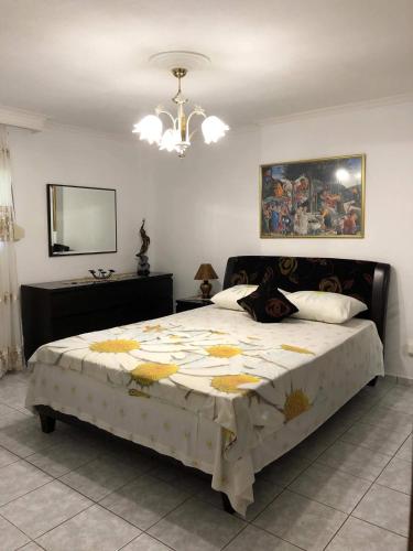 a bedroom with a large bed and a mirror at VILLA ELENA 5***** in Vromerí