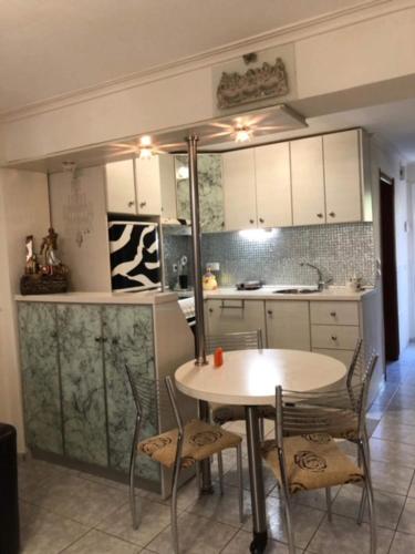 a kitchen with a table and chairs in a kitchen at VILLA ELENA 5***** in Vromerí