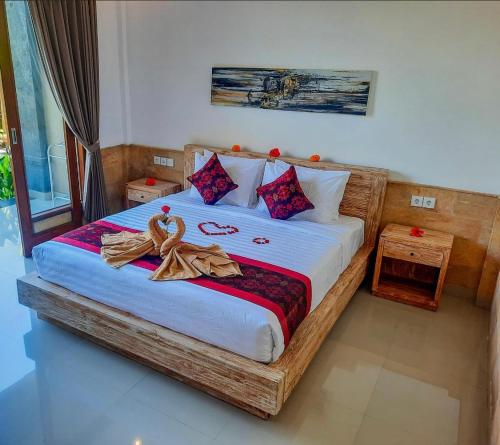 Postel nebo postele na pokoji v ubytování Pulu Sari Suite Ubud