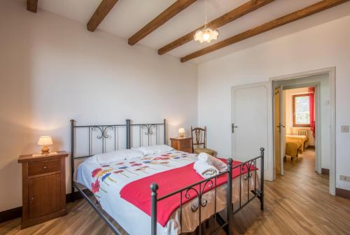 a bedroom with a large bed with a red blanket at La Zia Marisa in Montepulciano